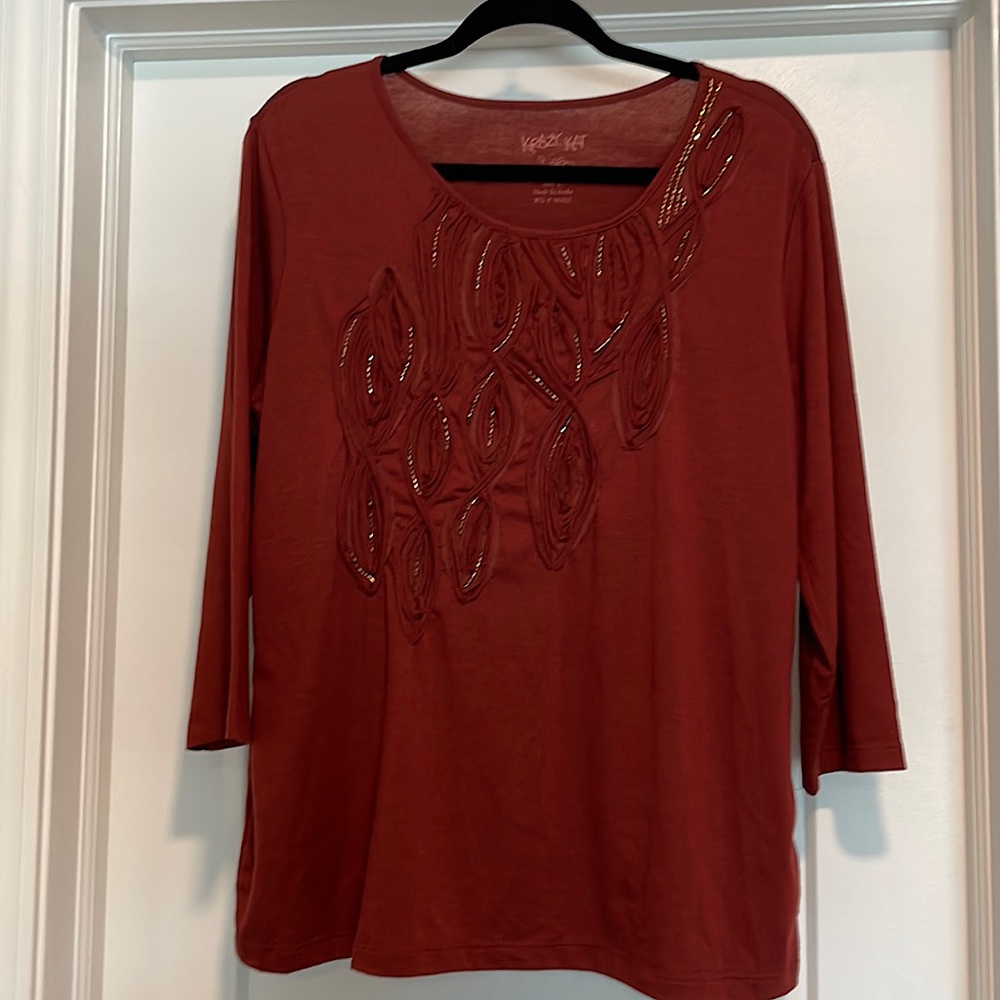 Dressy lightweight 3/4 sleeve top with embellishment.